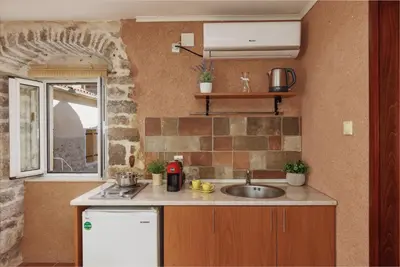 a small kitchen with a sink and a window at G-Apart in Kotor