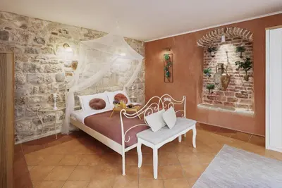 a bedroom with a bed with a canopy at G-Apart in Kotor