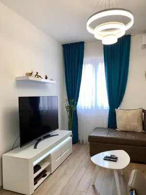 a living room with a couch and a flat screen tv at Apartmani Kažanegra33 in Pržno