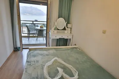 a room with a bed and a mirror and a window at Miracle in Budva