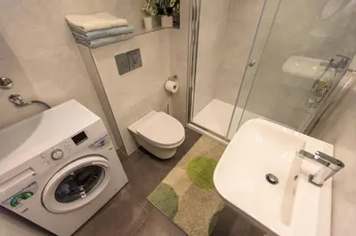 a bathroom with a washing machine and a sink at Miracle in Budva