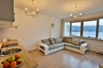 a kitchen and living room with a couch and a table at Miracle in Budva