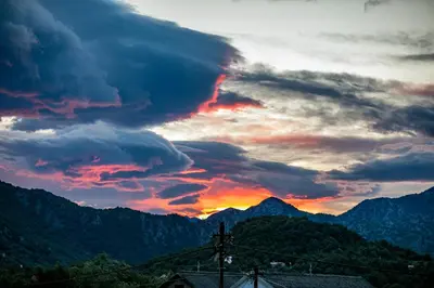 a sunset in the mountains with a cloudy sky at Ethno Lodge AB in Virpazar