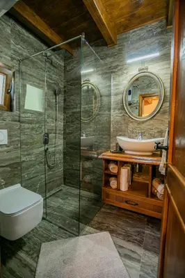 a bathroom with a shower and a sink at Ethno Lodge AB in Virpazar