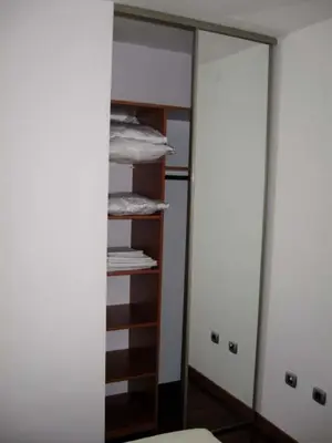 a closet with a mirror and a stack of towels at Apartmani Katarina in Budva