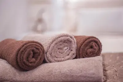 a pile of towels sitting on top of a bed at Luxury Boutique Studio Apartments in Budva