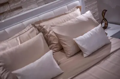 a white couch with four pillows on it at Luxury Boutique Studio Apartments in Budva