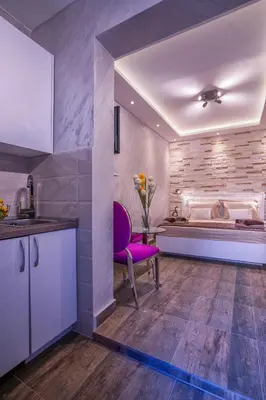 a kitchen with a purple chair and a table at Luxury Boutique Studio Apartments in Budva