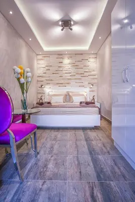 a bedroom with a bed and a purple chair at Luxury Boutique Studio Apartments in Budva