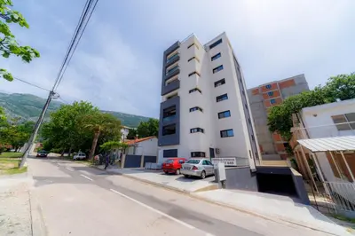 a tall white building on the side of a street at N Apartments in Sutomore