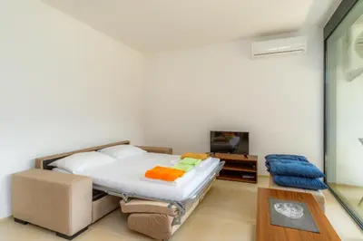 a bedroom with a bed and a tv at N Apartments in Sutomore