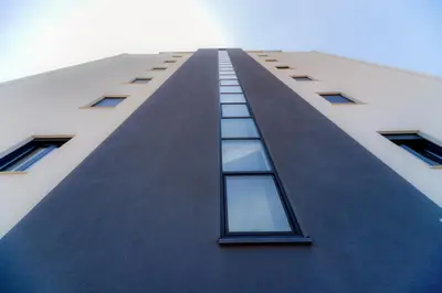 a tall building with windows on the side of it at N Apartments in Sutomore