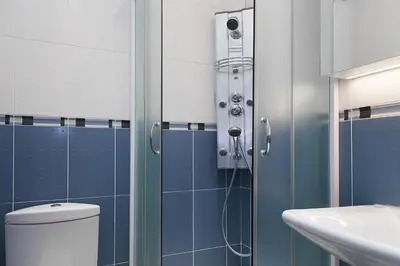 a bathroom with a shower and a toilet and a sink at Vidikovac Marble House in Budva