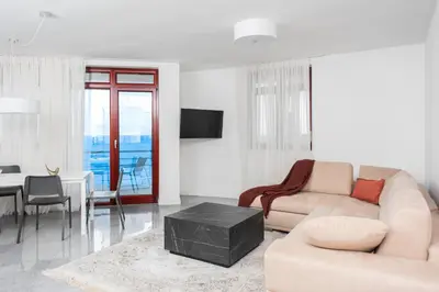a living room with a couch and a table at Vidikovac Marble House in Budva