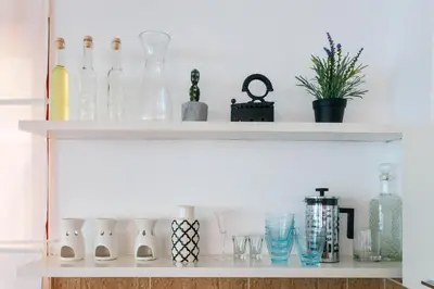 a shelf with bottles and glasses on it at Vidikovac Marble House in Budva