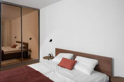 a bedroom with a bed with a mirror at Vidikovac Marble House in Budva