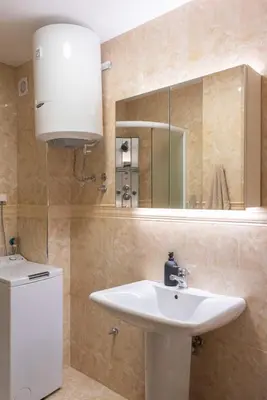 a bathroom with a white sink and a mirror at Vidikovac Marble House in Budva