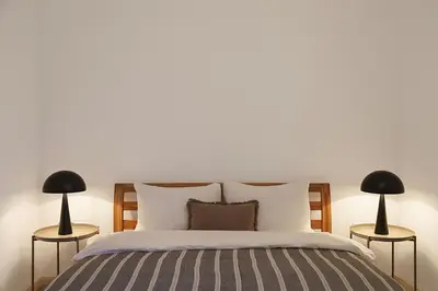 a bedroom with a large bed with two lamps at Vidikovac Marble House in Budva