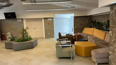 a lobby with a couch and chairs in an office at Hotel Castellastva in Petrovac na Moru