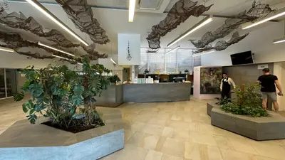 a lobby of a store with plants and a counter at Hotel Castellastva in Petrovac na Moru