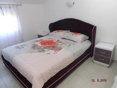 a bed with two pillows on top of it at Raj in Kotor