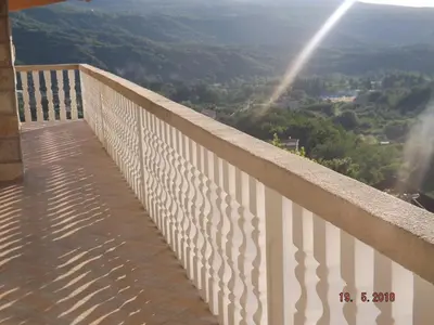 a balcony with a view of the mountains at Raj in Kotor