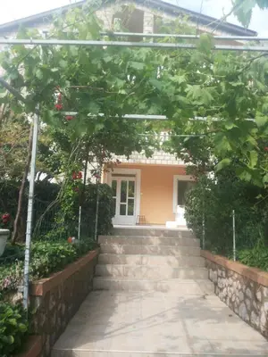 a house with stairs in front of a building at Raj in Kotor
