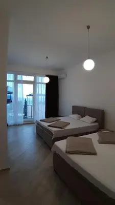 two beds in a room with a room with windows at Villa Roan in Bar