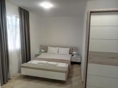 a small bedroom with a bed and a mirror at Villa Roan in Bar