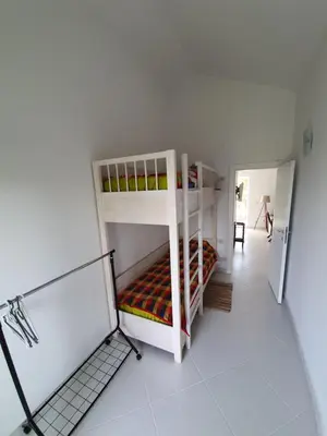 a room with two bunk beds and a hallway at Villa Rolla in Tivat