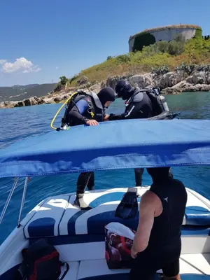 three people in wet suits on a boat in the water at Villa Rolla in Tivat
