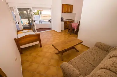 a living room with a couch and a table at Apartments De Lara in Utjeha