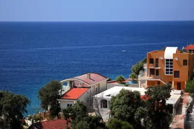 a group of buildings in front of the ocean at Apartments De Lara in Utjeha
