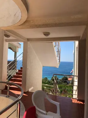 a room with a balcony with a view of the ocean at Apartments De Lara in Utjeha