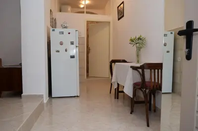 a kitchen with a table and a white refrigerator at Apartment Monika in Kotor