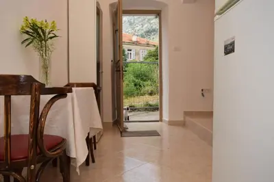a dining room with a table and a window at Apartment Monika in Kotor