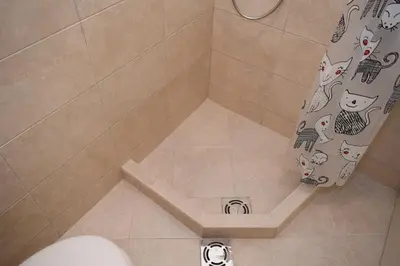 a shower curtain with cats and dogs on it in a bathroom at Apartment Monika in Kotor