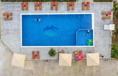 an overhead view of a swimming pool with people in it at Apartmani Djurovic in Dobra Voda
