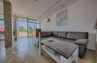 a living room with a couch and a table at Apartmani Djurovic in Dobra Voda