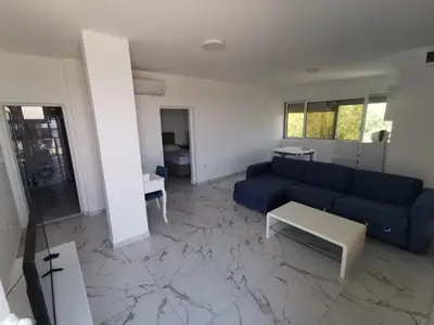 a living room with a blue couch and a table at Apartments Bibic in Budva
