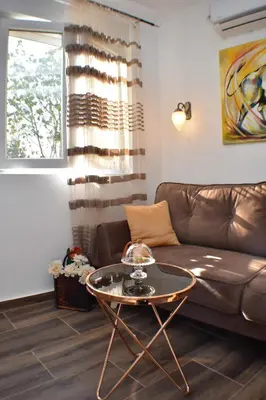 a living room with a couch and a table at Apartmani Ognjanovic Kotor in Kotor