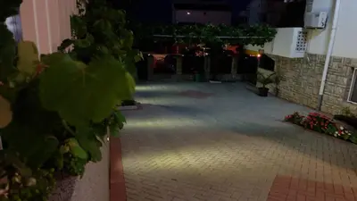 a room with a brick floor with lights on it at Apartments Kojic in Bar