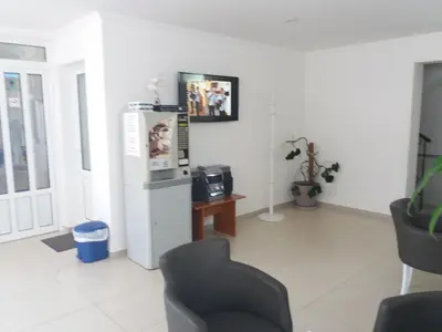 a living room with a refrigerator and a chair at Apartments Kojic in Bar
