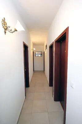 a hallway with two doors and a tile floor at Apartments Kojic in Bar