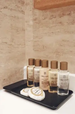 a tray with four bottles of paint on a counter at Hotel Villa Gracia in Budva
