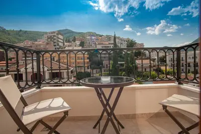 a table and two chairs on a balcony with a view at Hotel Villa Gracia in Budva