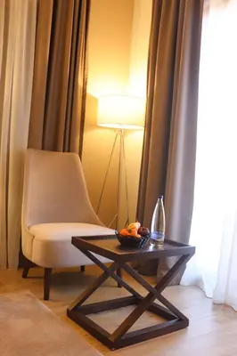 a living room with a chair and a table at Hotel Villa Gracia in Budva
