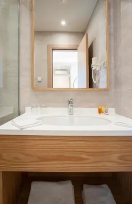 a bathroom with a white sink and a mirror at Hotel Villa Gracia in Budva