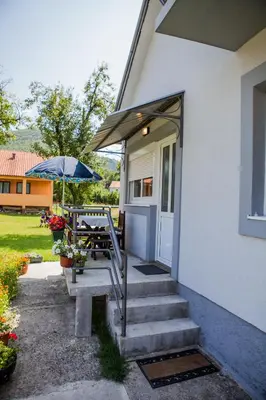 a patio with a table and an umbrella at Apartments Heaven in Cetinje