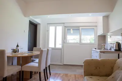 a kitchen and dining room with a table and chairs at Apartments Heaven in Cetinje
